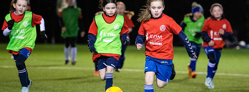 Girls playing grassroots football