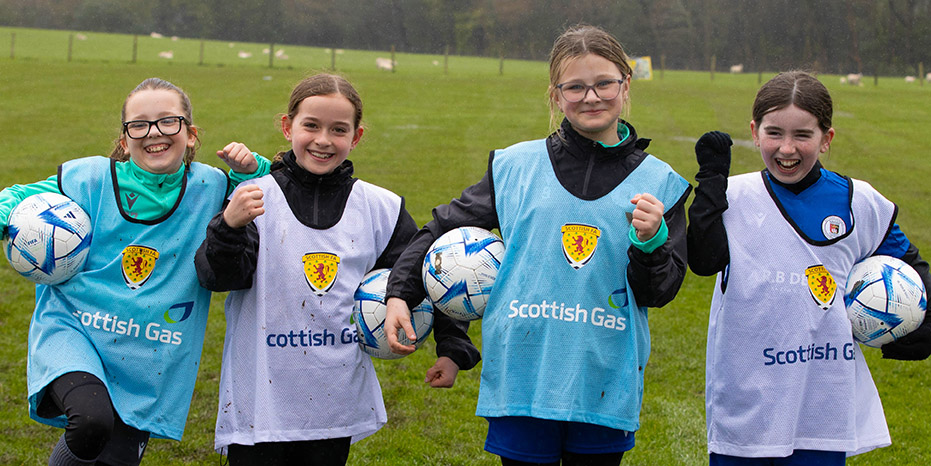 Four Scottish girls enjoying football