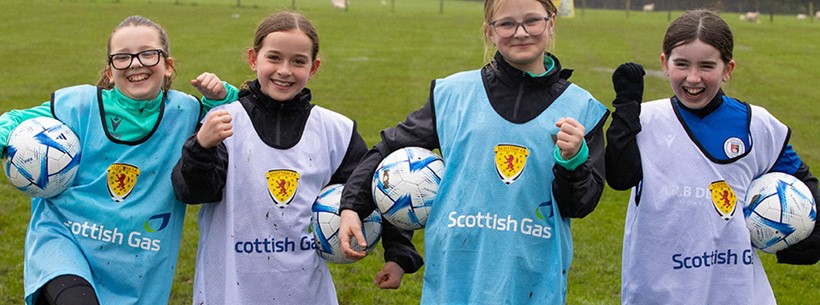 Four Scottish girls enjoying football