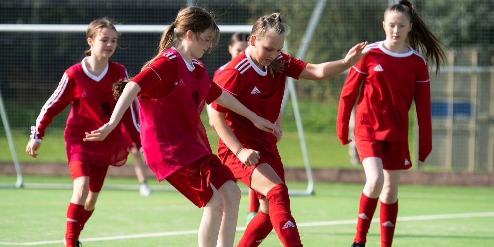Girls playing football