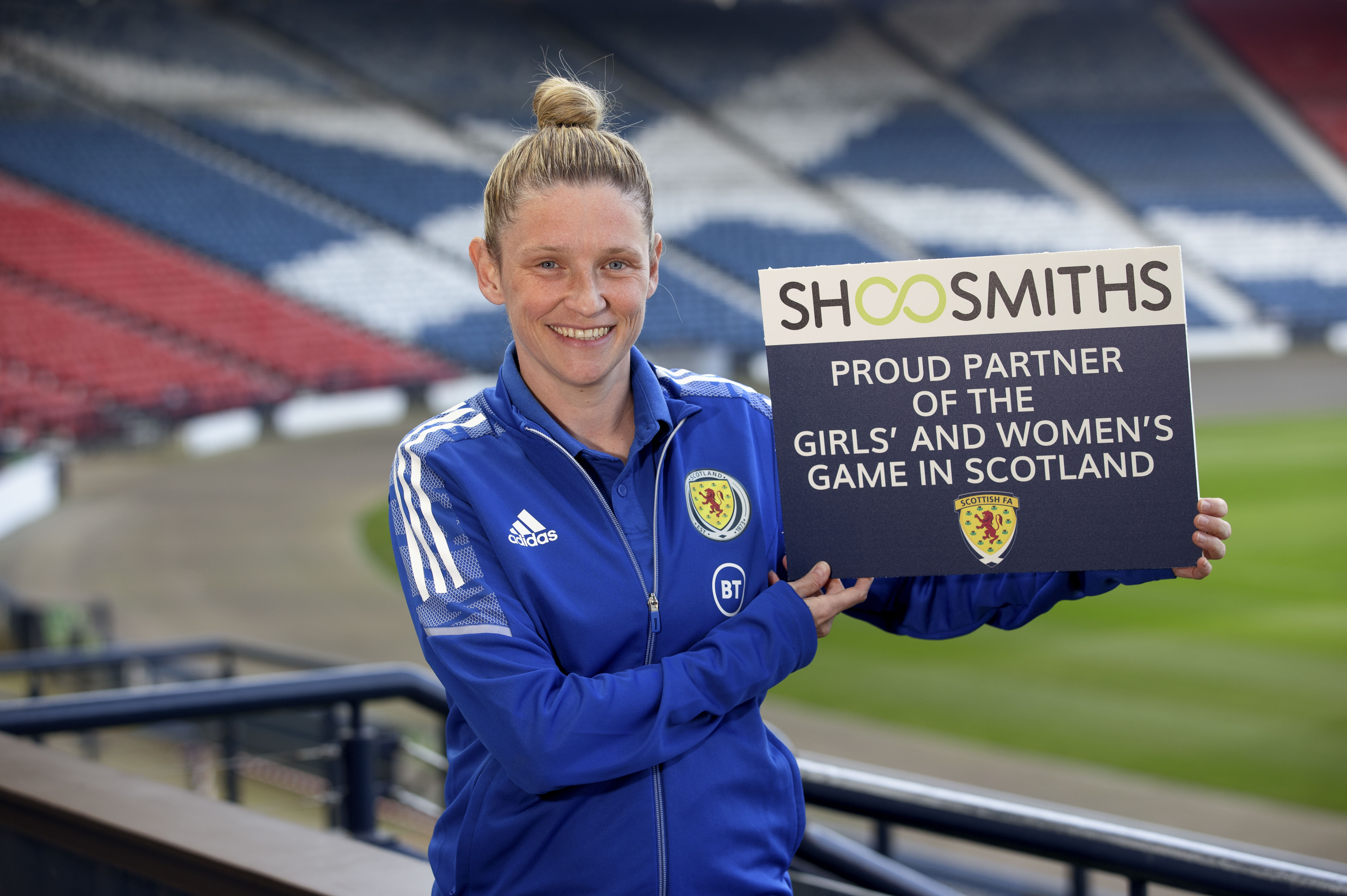 Leanne Ross holding up Shoosmiths partnership card